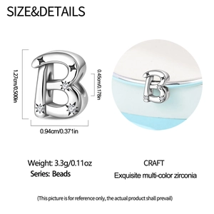 Detail macro view of letter B bead charm with star pattern and colorful zirconia stones