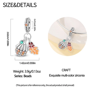 Detailed view of autumn acorn and maple leaf charm with orange stones and enamel finish