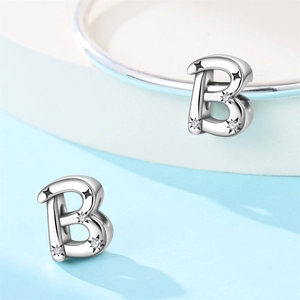 Detail of silver letter B charm with hollow star patterns and sparkling zircon stones