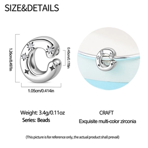 Macro view of C-shaped silver bead with multi-color zircon and star engraving