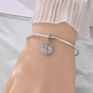 Macro shot of S925 silver bracelet featuring a shell charm with pink zircons and LOVE engraving