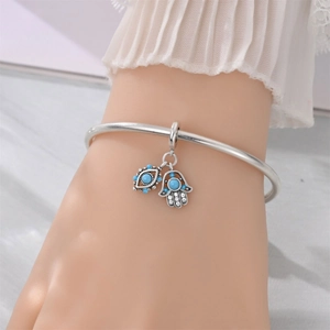 Silver Hamsa Hand and Evil Eye charm bracelet with blue details for women's fashion