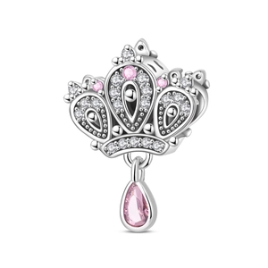 Detail of silver crown charm with pink pear-shaped gemstone and white crystals
