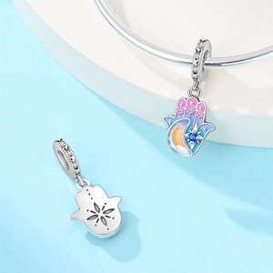 Detailed close-up of Hamsa hand charm with colorful enamel gradient and blue crystal