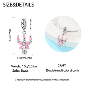 Detailed view of silver candlestick charm with pink bow and purple zircon measurements
