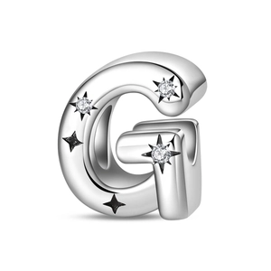 Detailed macro view of letter G silver charm bead with sparkling cubic zirconia inlay