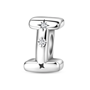 Detailed macro view of silver letter I charm with sparkling star-set zircon stones