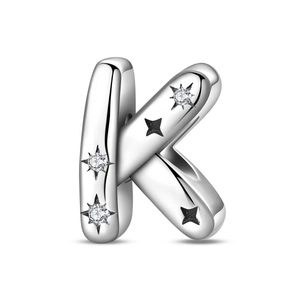Close-up of silver letter K charm with white zirconias and star details for DIY jewelry