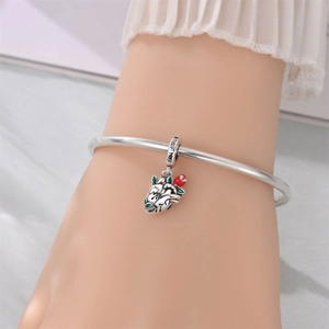 Detailed view of silver heart and rose charm on bracelet with 'heal my' engraving
