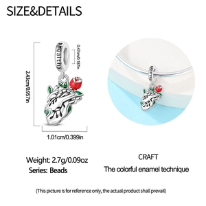 Detailed view of silver heart charm with red rose enamel and healthy engraving