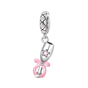 Macro detail of silver charm with pink star zircon and enamel bow for DIY bracelet