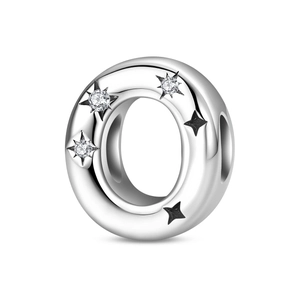 Macro view of silver plated star charm with cubic zirconia and black star details