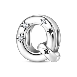 Detailed view of silver letter Q charm with star engravings and cubic zirconia stones