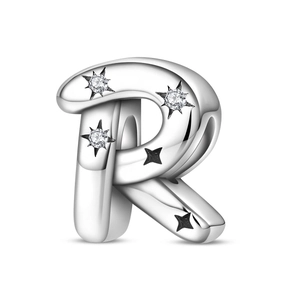 Detailed macro view of silver letter R charm with star-set cubic zirconia stones
