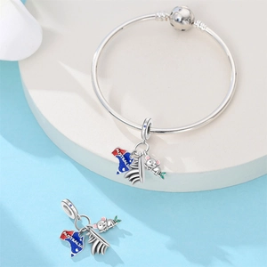 Silver snake chain bracelet with Australia map, koala, and opera house charms on a pedestal