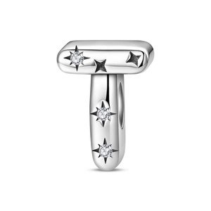 Macro detail of silver letter T charm with star-engraved zircon for DIY jewelry