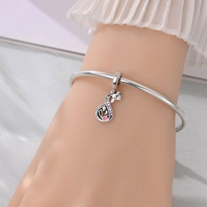 Detail view of silver infinity charm with pink stones and Forever Love engraving