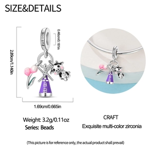 Detail of Holland charm featuring purple enamel windmill, cow, and tulip pendant