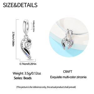Detailed view of silver heart pendant charms with Fall to him and Fall to she engravings