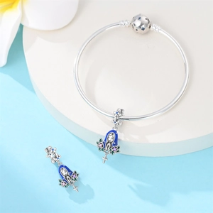 Close-up of silver-plated bracelet with blue enamel Virgin Mary charms and cross details