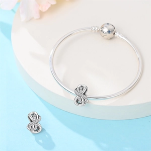 Silver infinity charm bracelet set with sparkling zircons and blue star clasp detail