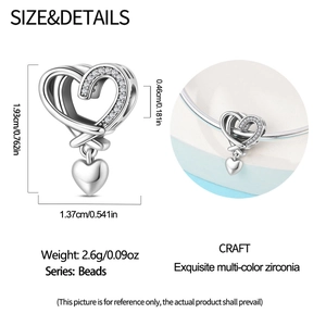 Macro detail of silver heart charm with multi-color zirconia and dimensional measurements