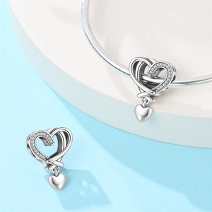 Silver openwork heart charm with pavé stones and hanging mini heart for bracelets