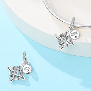 Detailed macro view of Celtic knot charm with Happy Forever engraving and stones