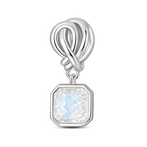 Detail of silver knot charm with octagonal moonstone pendant for DIY bracelets