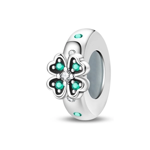 Detailed close-up of silver four-leaf clover charm with green cubic zirconia stones