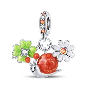 Detail of silver clover, snail and daisy charms with colorful enamel and zircon stones
