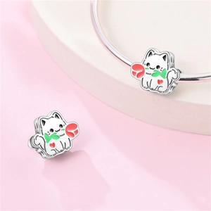 Vista macro di charm a gatto in argento con rosa rossa e cuore su bracciale