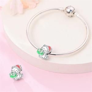 Dettaglio del bracciale d'argento con ciondoli a gatto natalizio e dettagli in smalto