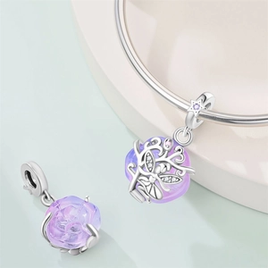 Silver charm with lavender gemstone, butterfly cutouts and zircons on silver bracelet