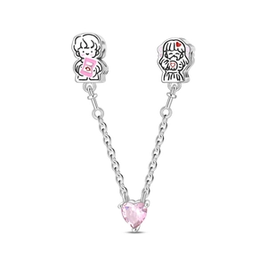 Safety chain charm with enamel boy and girl figures and a pink heart-shaped crystal