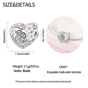Detail of silver heart charm with pink enamel flowers and couple silhouette engraving