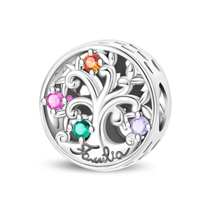 Macro detail of silver Tree of Life charm with colorful gems and Family engraving