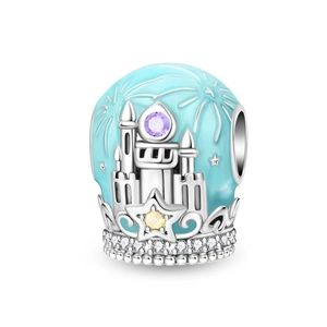 Macro shot of silver castle charm with blue enamel, purple gemstone and star detail