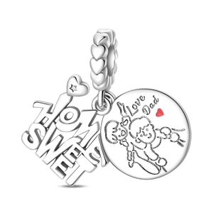 Macro detail of Home Sweet and Love Dad silver charms with a red enamel heart on a bead