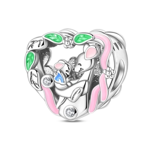 Macro detail of heart-shaped silver charm with mother and child mouse enamel design