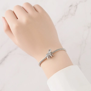 Detail of silver elephant charm with intricate ethnic engraving on snake chain bracelet
