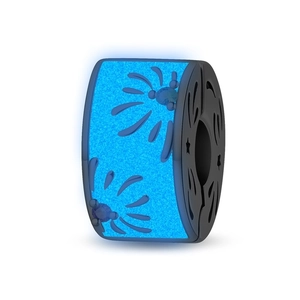 Macro detail of spider charm with blue glow material and star moon cutout patterns