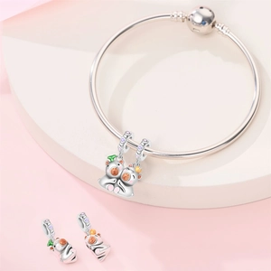 Macro view of silver snake chain bracelet featuring colorful animal charms and purple zircons