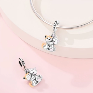 Detailed view of silver cat charm with LOVE engraving and colorful enamel accents