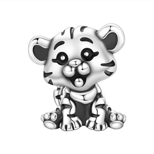 Close-up of cute silver tiger charm with black enamel details for DIY jewelry