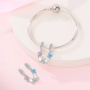 Close-up of silver-plated pinky swear charms with pink and blue enamel on a bangle