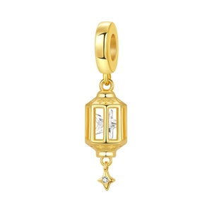 Macro detail of gold lantern charm with star crystal and zircon pendant for bracelets