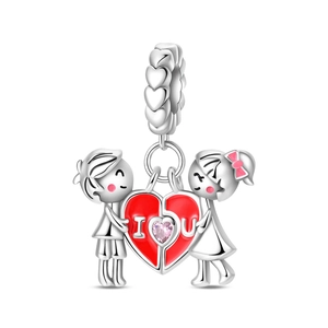 Macro shot of silver cartoon couple charm with red heart and I Love You engraving
