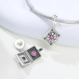 Detail of book charm with star motif, pink gem, and Only You engraving on snake chain