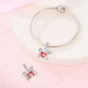 Detail of silver heart charm with boy and girl design and engraved I love U text